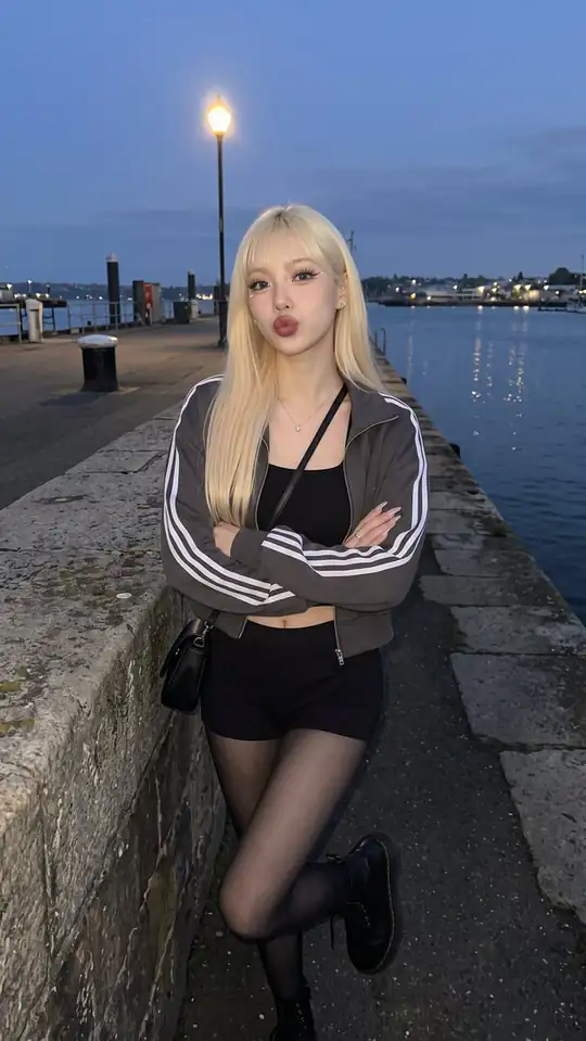 Vivian in a photo from her slideshow "harbor after dark hits different".
